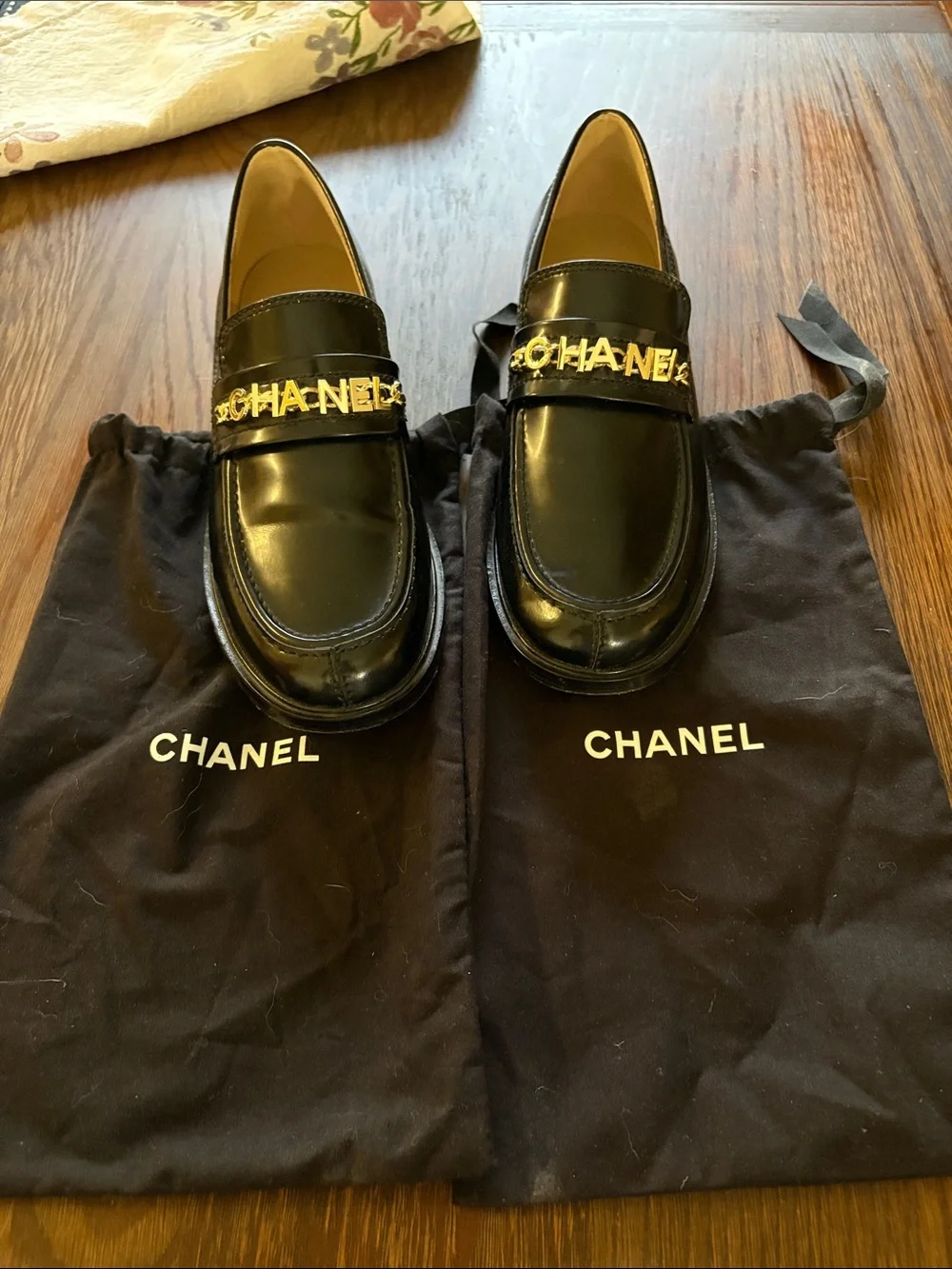 CHANEL Black Leather Loafers with Gold Logo Chain